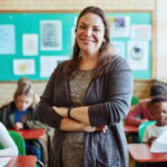 Confident young woman teaching children, symbolizing passion in work