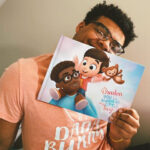 A happy man with a personalized book for daddies, showcasing a joyful moment of connection and love.