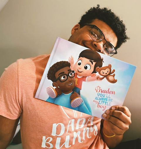 A happy man with a personalized book for daddies, showcasing a joyful moment of connection and love.