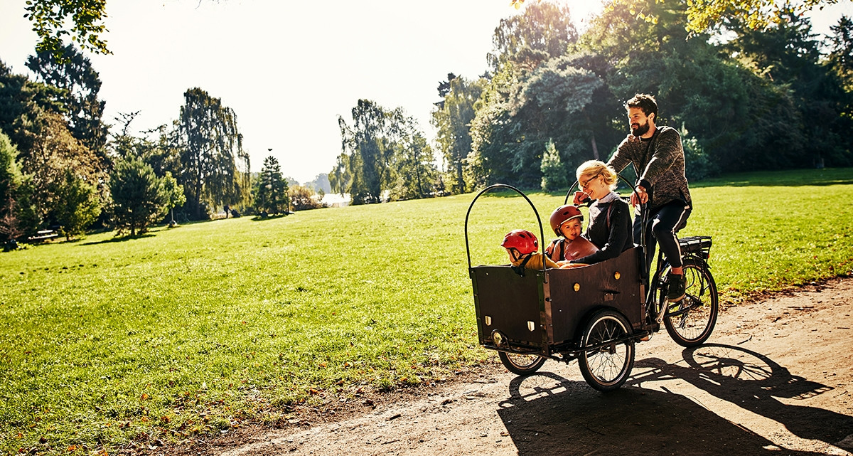 Parents show their love by taking their children on a bike ride through the park.