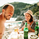 Couple enjoy a romantic coastal holiday.