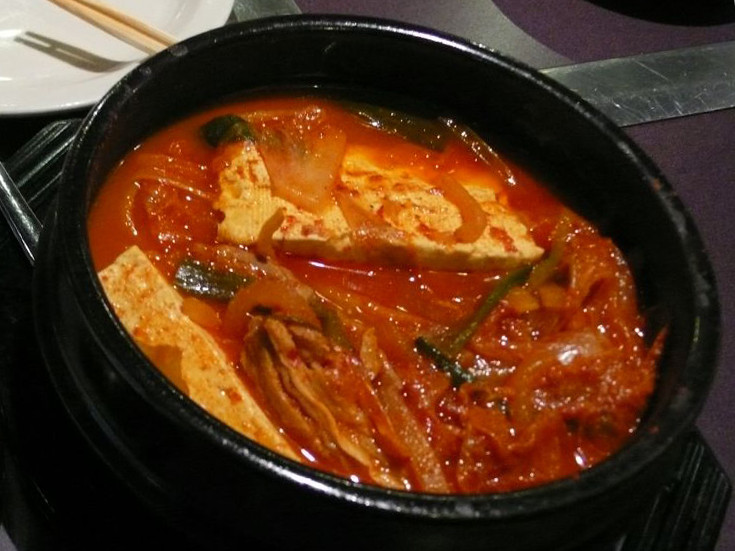 Kimchi Jjigae, a quintessential Korean stew made with kimchi and other ingredients, known for its spicy and savory flavor.