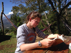 Sadie immersed in a book, discovering the Spanish language and love during her Traveling School semester. Learn Spanish phrases like 'Are you my love in Spanish?' while exploring new cultures.