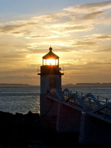 Woman walking towards a hopeful sunset on a path