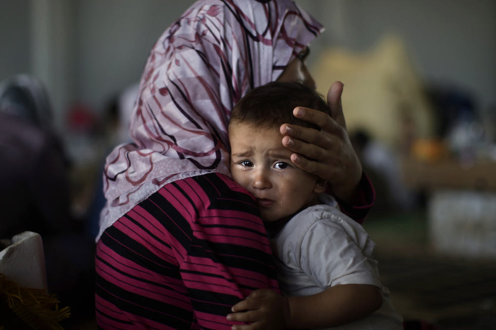 A Syrian mother and child amidst the devastation of war.