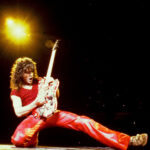 alt text: black and white photo of Eddie Van Halen playing guitar