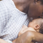 A mother breastfeeding her baby, highlighting the role of oxytocin in bonding and milk production.